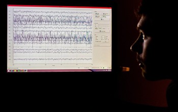 man looking at EEG data on the screen